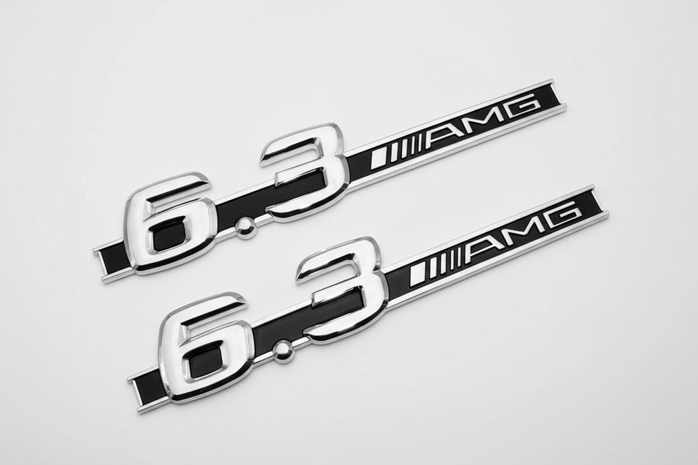 Two metallic '6.3 AMG' emblems on a white background 