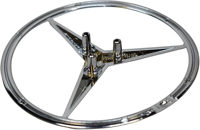 Chrome car emblem with star design on a white background
