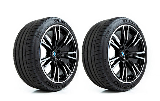 Two black BMW wheels with silver multi-spoke accents and black Michelin tires, shown side-by-side on a white background.